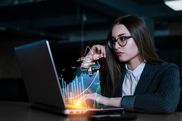 a woman looking at a laptop screen